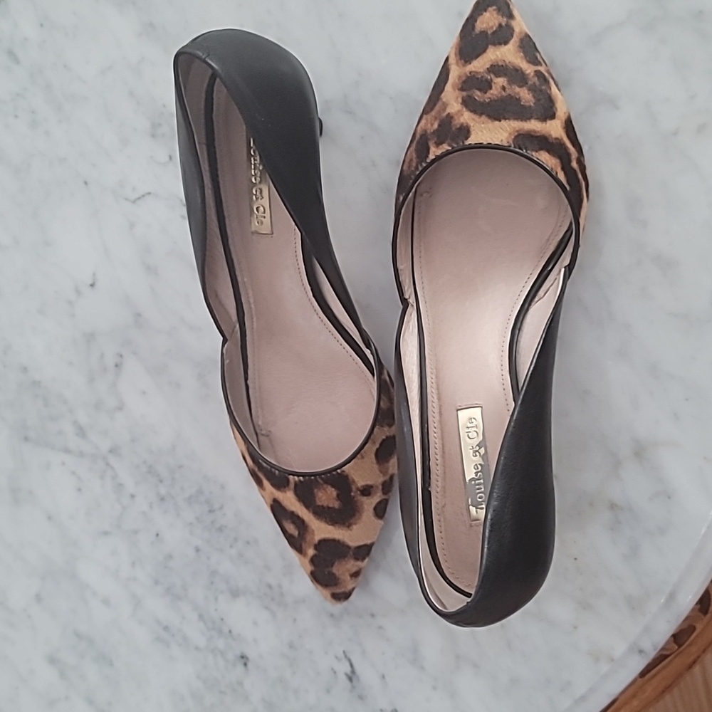 Leather dressy pointed-toe pumps with kitten heels. Leopard-print felt accent